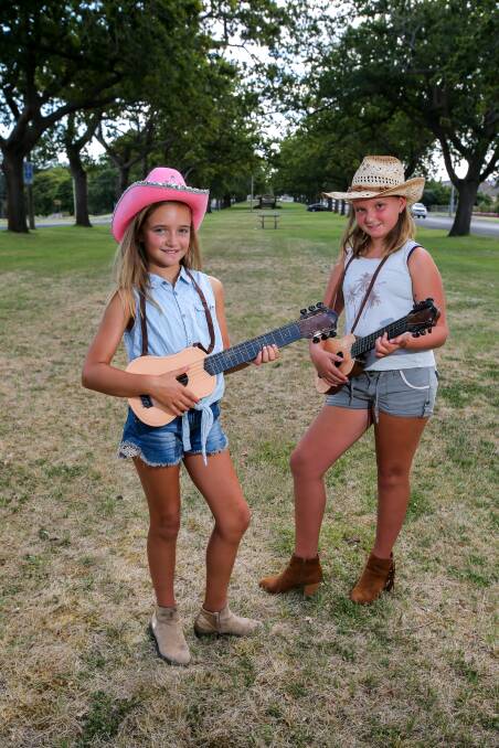 Sister act: Sema, 9, and Leyla Meric, 10, are pulling their boots on and getting their hats ready for the cowboy and cowgirl competition. Picture: Rob Gunstone