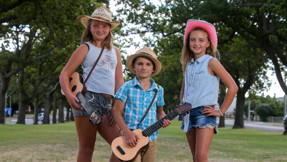 Leyla Meric, 10, Emre Meric, 5,and Sema Meric, 9, are pulling their boots on and getting their hats ready for the cowboy and cowgirl competition at the Terang Music Festival. Picture: Rob Gunstone
