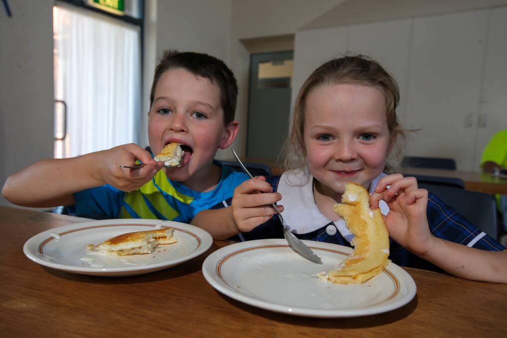 Savoury or sweet?: Warrnambool siblings Zac Burrows, 8, and Sophie Burrows, 6, were enjoying a plate-sized pancake with icecream at the Uniting Church's annual Pancake Day on Tuesday. Picture: Rob Gunstone