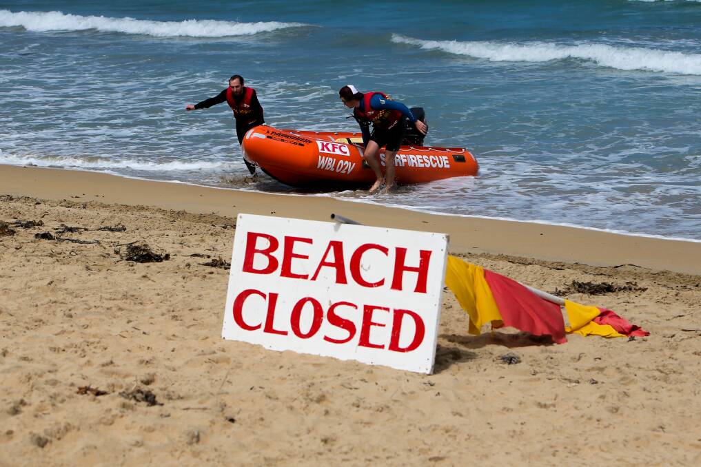 Warrnambool surf lifesavers use the inflatable rescue boat to warn swimmers of Monday's shark sighting. Picture: Rob Gunstone