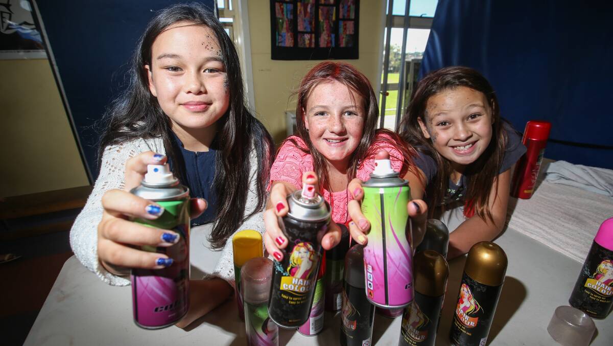 Colourful: West Warrnambool Primary students Anzyha Folima, 10, Tralee Giblin, 10, and Bella Folima, 9, helped run the school fete's hairspray table. Picture: Amy Paton