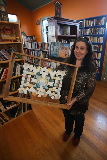 WORD ART: Jo Canham of Blarney Books with the winning artwork from last year's Biblio Art Prize, a piece by Sinead Murphy.  Picture: Morgan Hancock