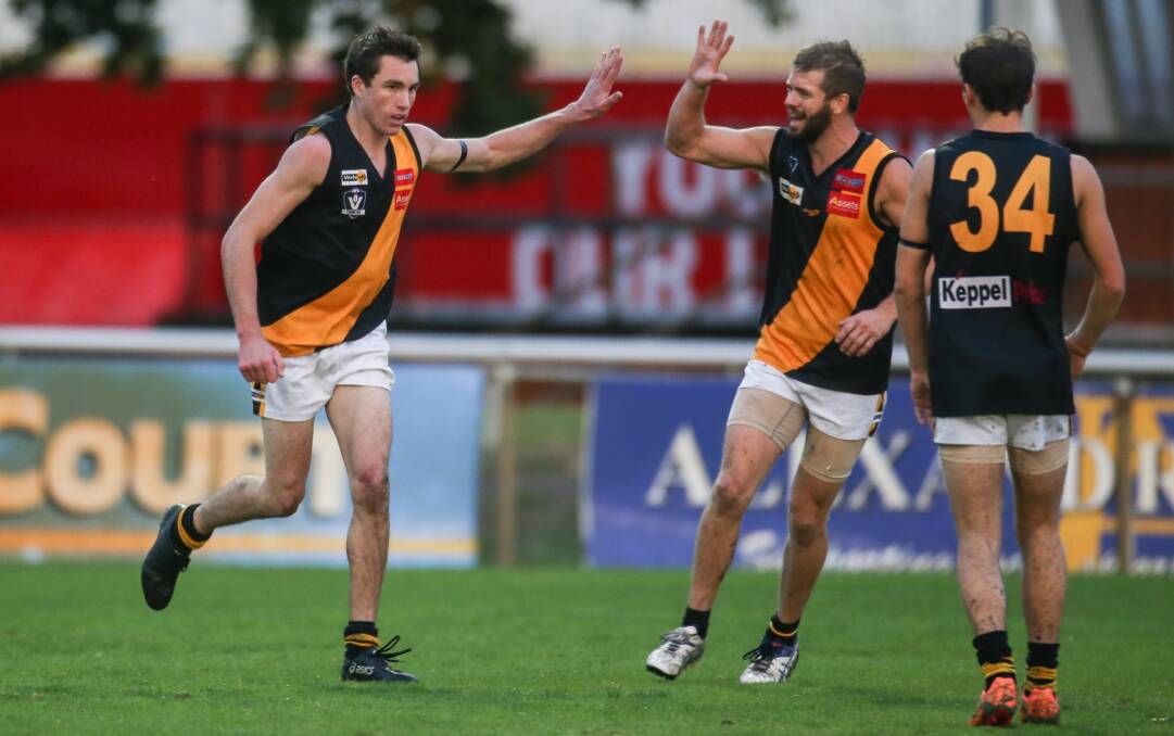 HE'S BACK: Portland player Matt Kelly celebrates with Rhys Egan after kicking a goal on Anzac Day, his most recent appearance for the Tigers.
