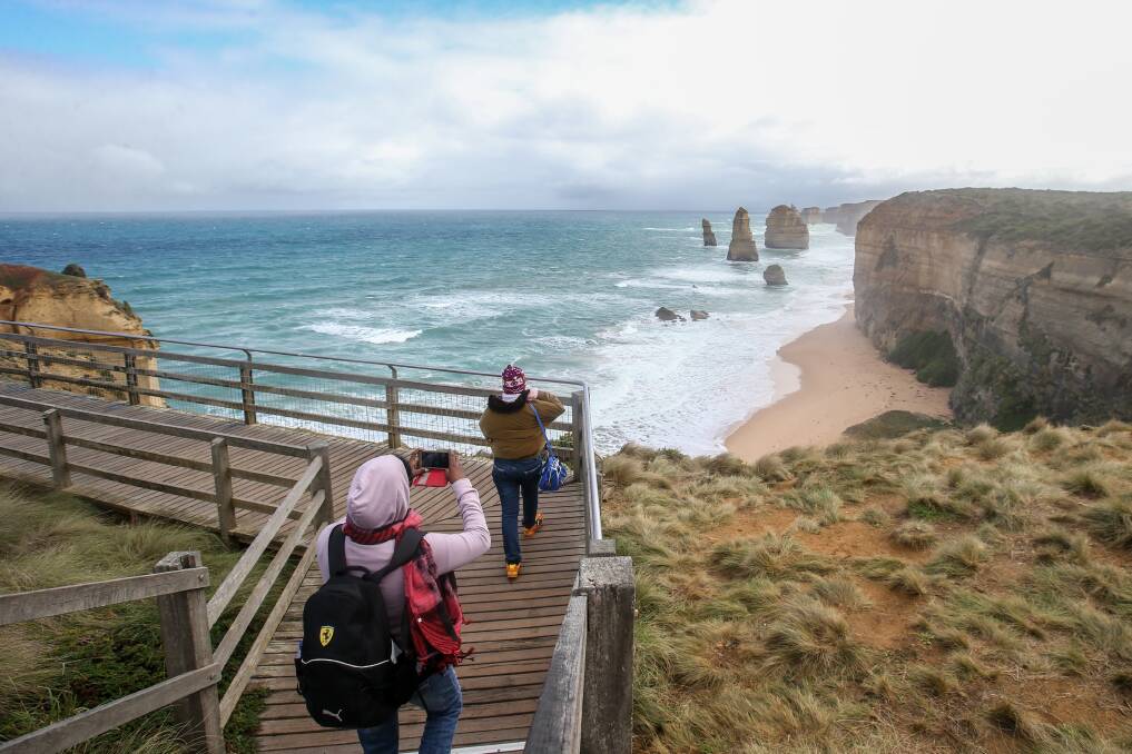 Happy snap: Tourists photographing the Twelve Apostles in April. They might have to pay for the opportunity in future under an MP's plan. Picture: Amy Paton