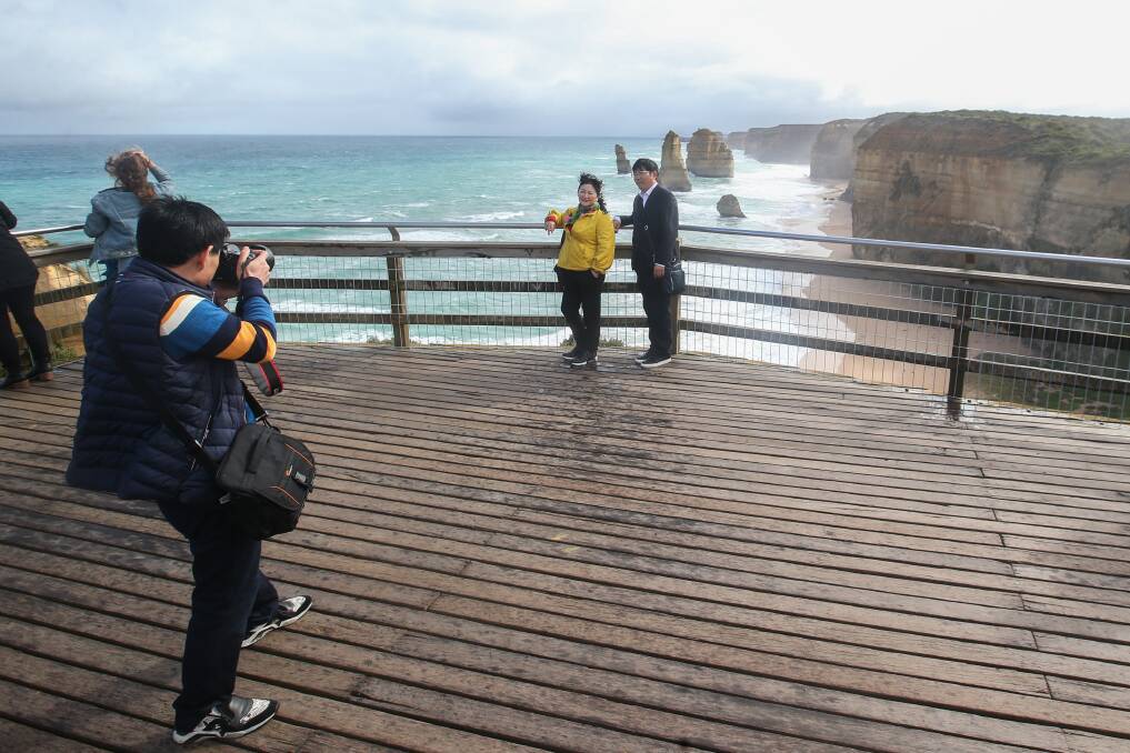 Tourists take photos at the Twelve Apostles. 