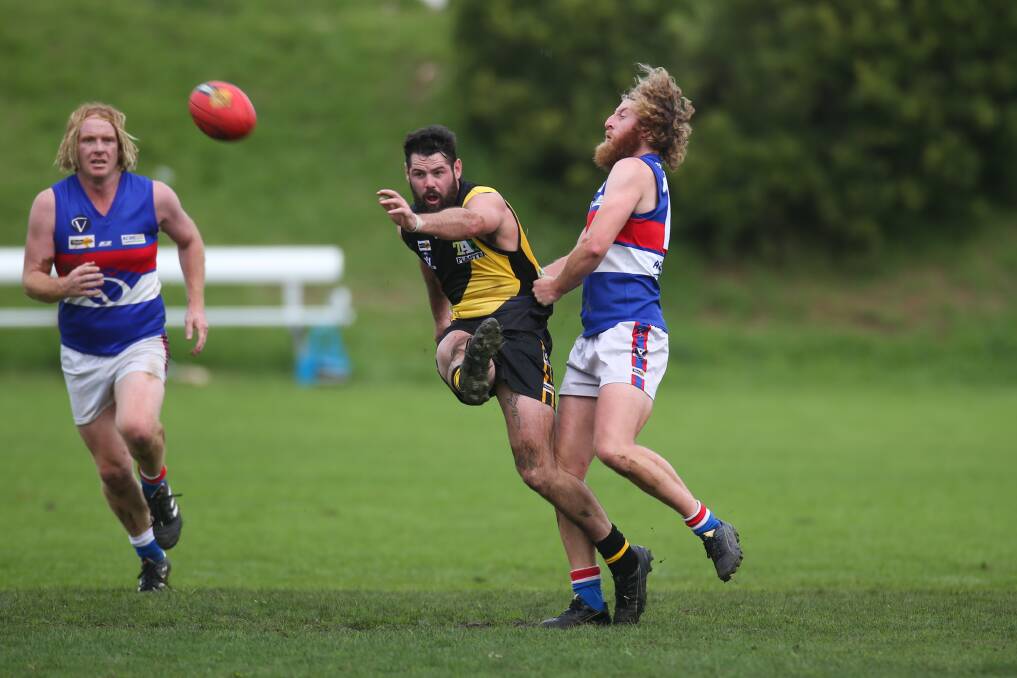 UNDER PRESSURE: Merrivale kicks the ball while getting tackled by Panmure's Shaun Griffin. Picture: Morgan Hancock