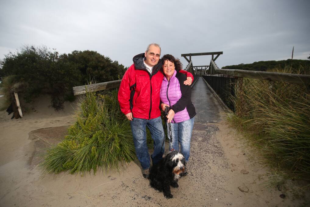 RAIN, HAIL OR SHINE: Udo and Ellen Troitzsch and their dog, Oliver, don't understand why Warrnambool isn't more widely promoted. They love the city and moved here two weeks ago. Picture: Morgan Hancock   