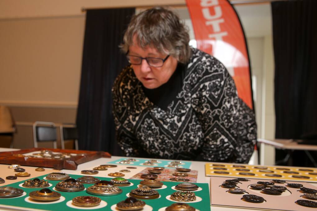 WOW: Victorian Button Collectors' Club president Mary Bingham examines some of the display in the Port Fairy Drill Hall. Pictures: Rob Gunstone
