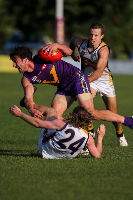 CRUNCH TIME: Port Fairy's Matthew Sully gets out of a tackle by North Warrnambool Eagles' Ben Fleming as Matthew Wines closes in. Picture: Rob Gunstone