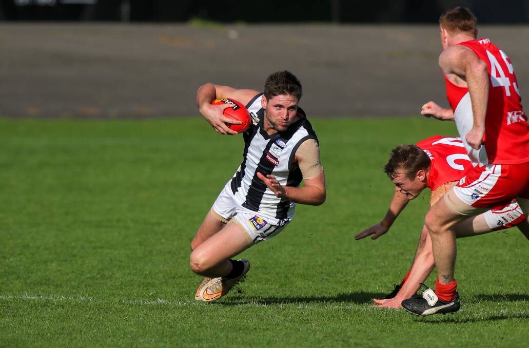 SLIP AND SLIDE: Camperdown's Jordan Bain loses his footing under pressure from a couple of Roosters. Picture: Rob Gunstone