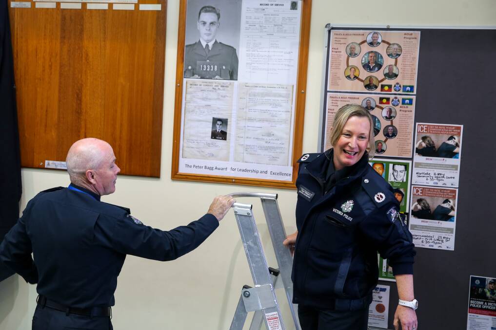 Warrnambool superintendent Peter Greaney helps Assistant Commissioner Tess Walsh unveil the Peter Bagg Award display. Picture: Rob Gunstone