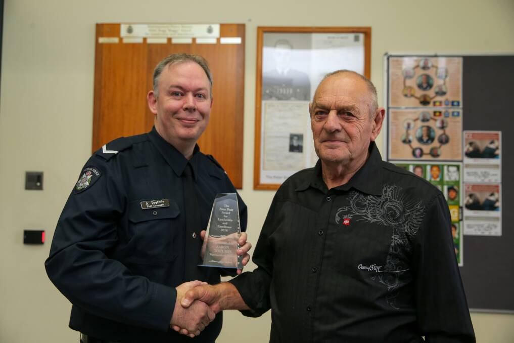 CONGRATULATIONS: First Constable Aaron Toulmin shakes hands with former police officer Peter Bagg, after receiving the award named in Mr Bagg's honour. Picture: Rob Gunstone