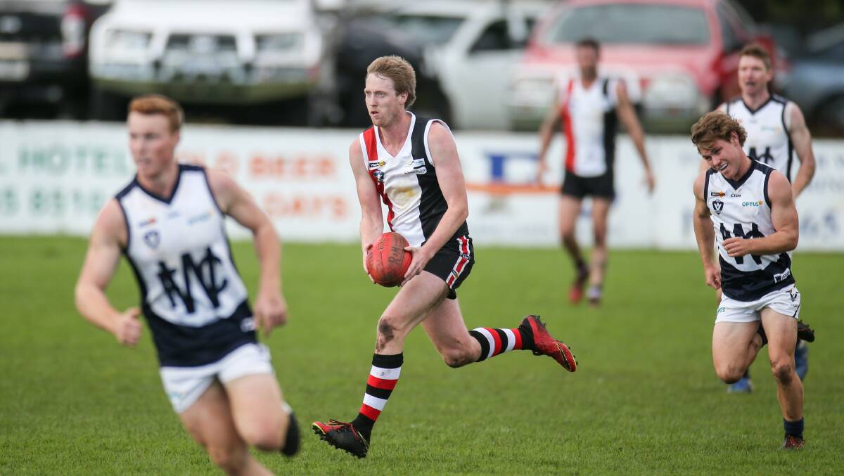 CHANGING ROLE: Koroit's Dallas Mooney runs the ball through the midfield against Warrnambool on Saturday. Picture: Amy Paton