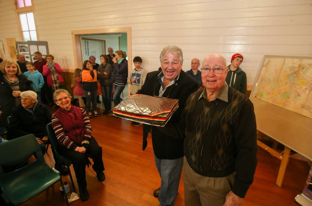 Celebrations: Moyne Shire mayor Jim Doukas and long-time Purnim resident Ray Eccles with a celebratory cake. Picture: Amy Paton