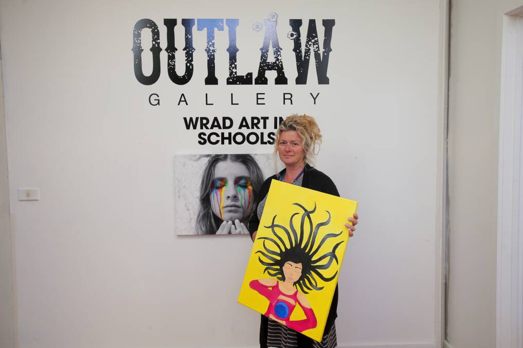ART FOR A CAUSE: WRAD's Angela Alexander holding one of the paintings that will be on show in the Art In Schools exhibition, which opens on Thursday. Picture: Morgan Hancock