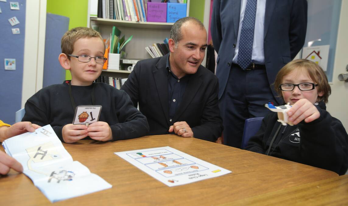 Eye to eye: Education Minister James Merlino talks to Warrnambool Special Developmental School students Lewis Leslie-Inman, 8, and Caleb Whitten, 8, during a tour of the school site. Picture: Rob Gunstone