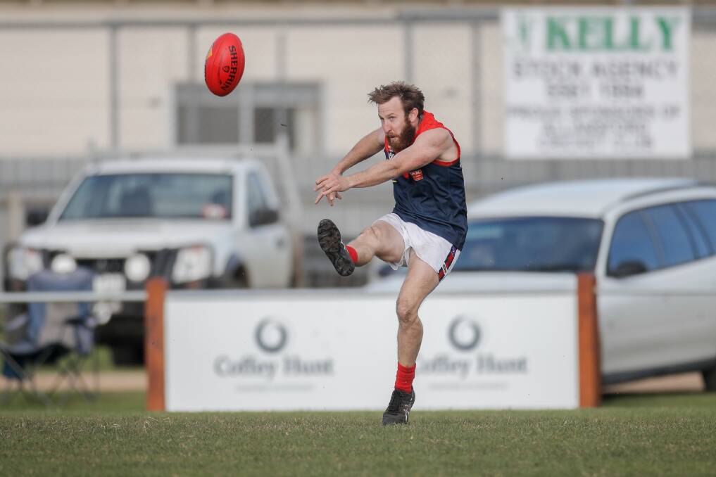 BOOTING IT: Timboon Demons player Ben Newey kicks the ball towards the middle of the ground during Saturday's win over Allansford. Picture: Amy Paton
