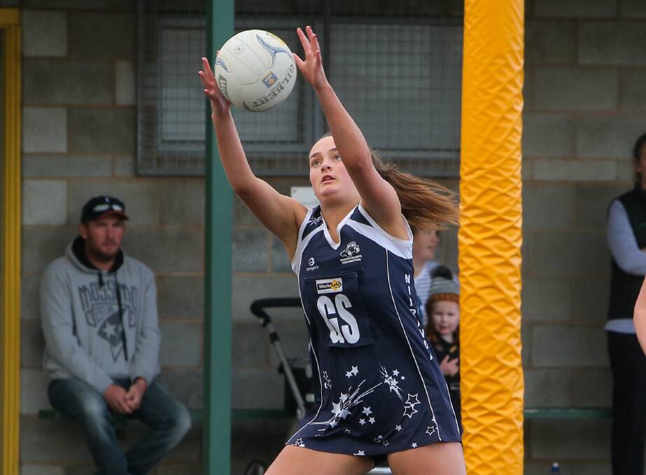 REACHING UP: Nirranda goaler Sophie Adams shot 32 goals at home and was among the Blues' best in Saturday's comfortable win over Timboon Demons.