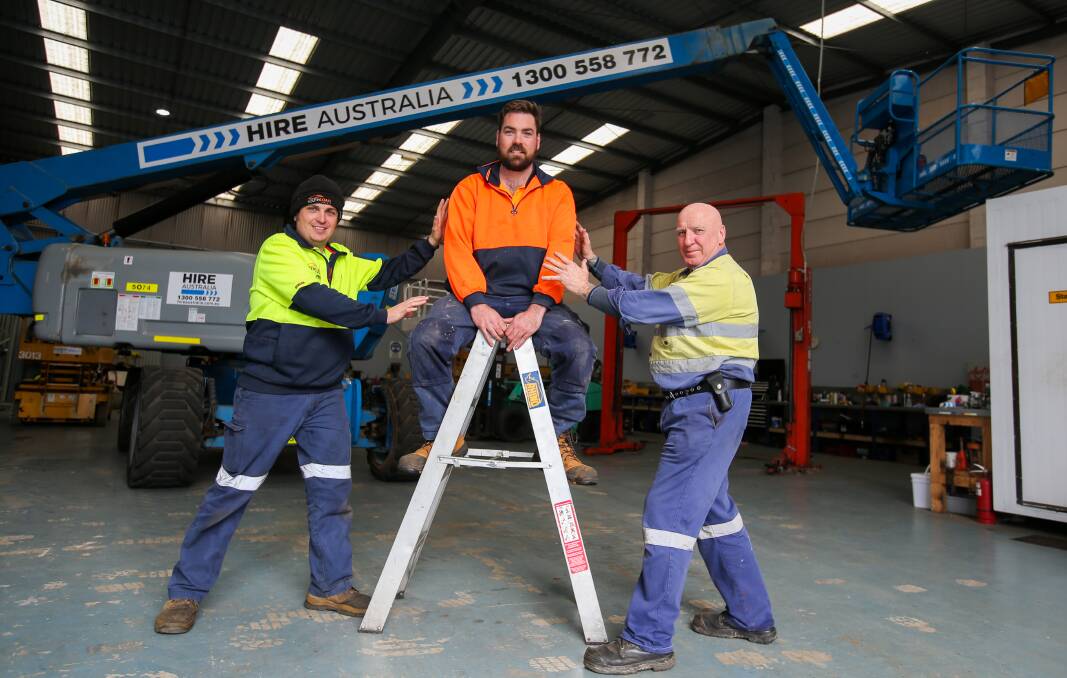 In the air: Chris Dowling (centre) will test his fear of heights in a 60 metre high boom lift run by Matt Reeves (left) and Pete Smith, South Coast Forklifts. Picture: Rob Gunstone