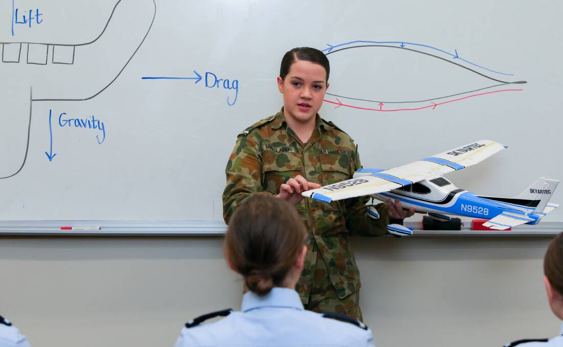 TEACHING: Cadet Corporal from Australian Air Force Cadets 413 Squadron Imogen Marsland, 15, discusses the forces that act on an aircraft. Picture: Rob Gunstone