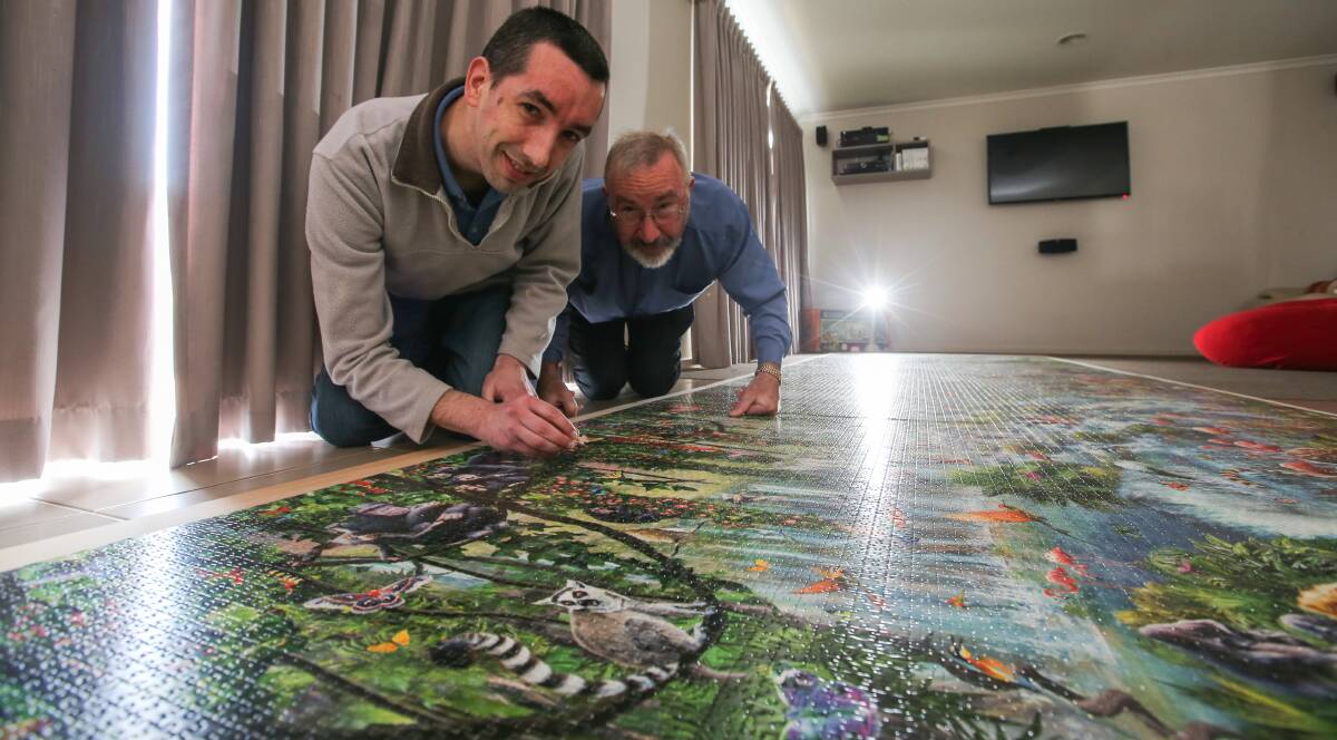 Piece by piece: Warrnambool's Ben Philpot and his father John have just finished a 33,600-piece jigsaw puzzle. Picture: Rob Gunstone