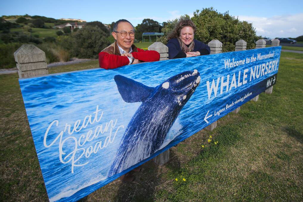 Great image: Photographer Perry Cho and Warrnambool mayor Kylie Gaston admire the new sign promoting the Logans Beach whale nursery. Picture: Morgan Hancock