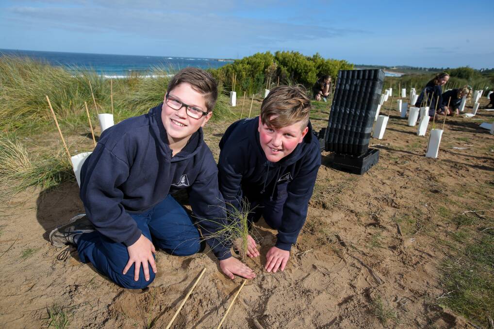 HANDS ON: Our Lady Help of Christians Primary School students Archie Lenehan and Tom Vogels planting grasses. 