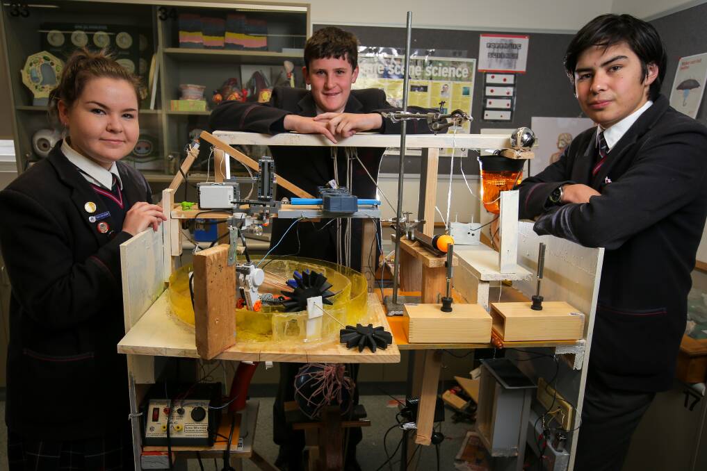 Brain power: Emmanuel College science club members Piper Hinkley, 16, Jacob Gome, 14, and Liam Flaherty, 16, work on finishing their can-crushing spaghetti machine. Picture: Rob Gunstone