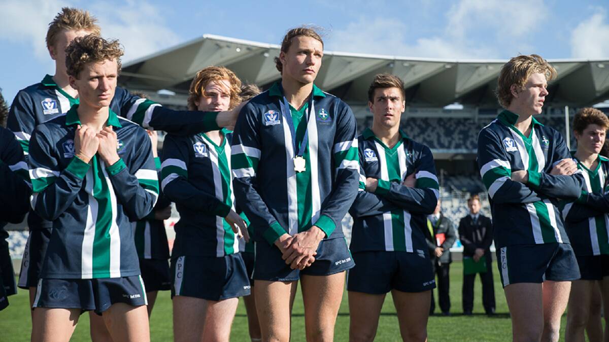 FORLORN: The St Patrick's team - along with best on ground Tom Scott, from Hamilton Kangaroos - cut dejected figures after going down in the Herald Sun Shield final. Picture: Arj Giese/AFL Victoria