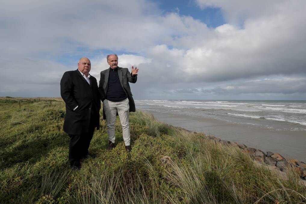VIEW TO A LANDFILL: State Treasurer Tim Pallas listen to Moyne Shire's Oliver Moles discuss the state of the old Port Fairy tip site along East Beach. Picture: Rob Gunstone