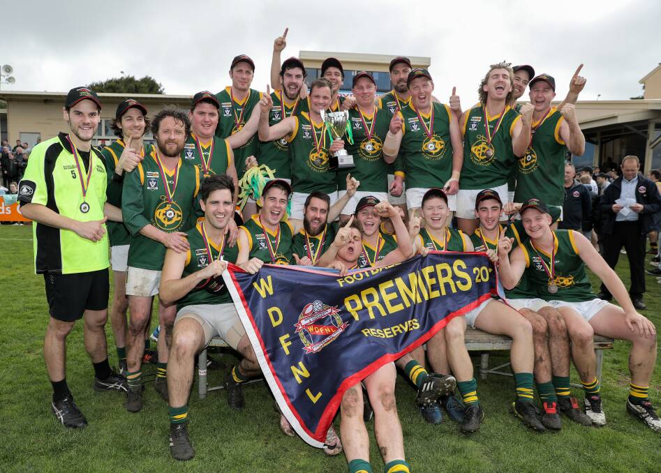 DROUGHT-BREAKERS: Old Collegians players receive the reserves premiership cup and flag, and celebrate their victory. Picture: Rob Gunstone