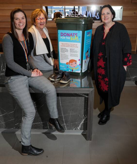 Help: Beyond the Bell's Catherine Darkin and Glenys Phillpot and Sinclair Wilson partner Felicity Melican with the Donate for the Kids bin. Picture: Rob Gunstone