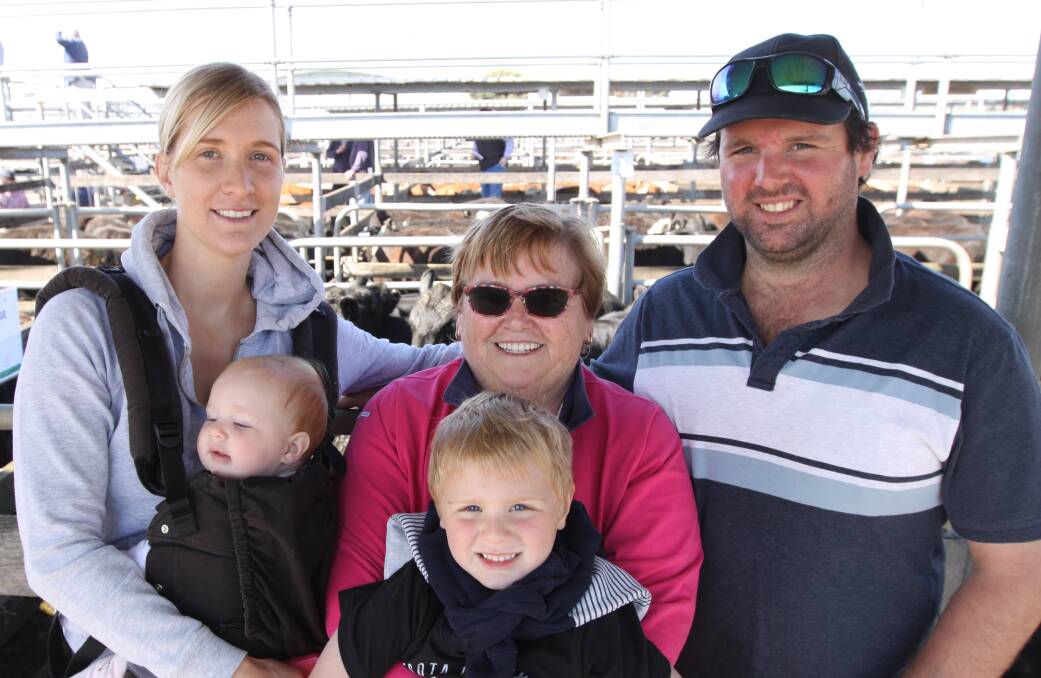 Upturn in prices: Erin, left, with baby Jorja, Codi, Carolina, and T.J. Symons, of Ballangeich, gained $3.18c/kilograms for 13 steers averaging 377 kgs at the sale.
