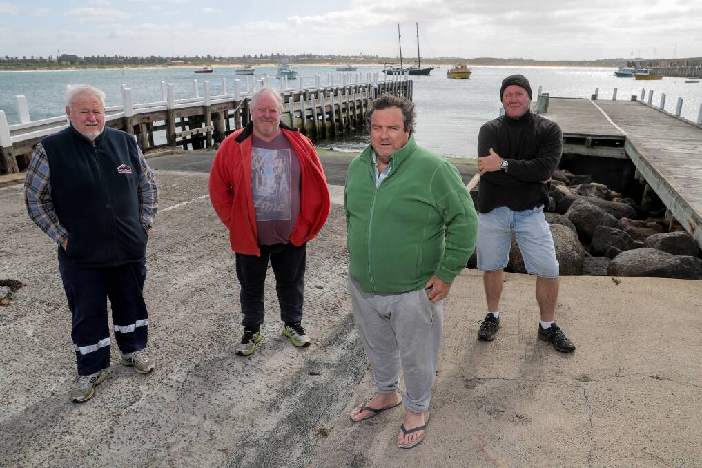 FIX IT: Neville Dance from Warrnambool Offshore and Light Game Fishing Club, professional fisherman Peter Sandow, master mariner Rod Blake and Coast Guard's Steve Tippett at the boat ramp and harbour. Picture: Rob Gunstone