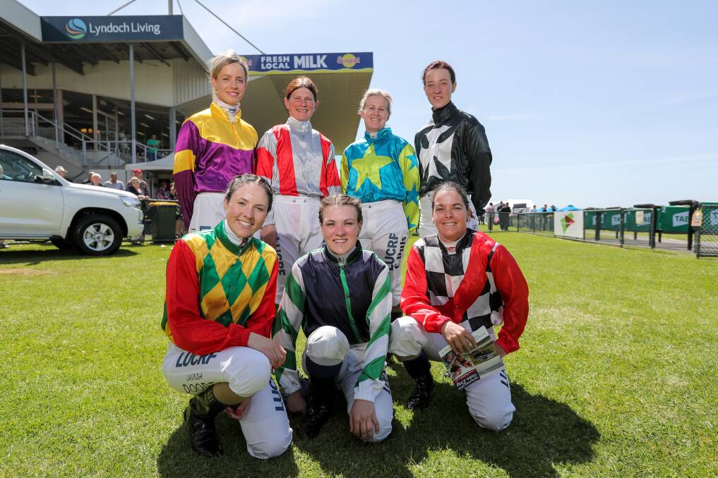 SAY CHEESE: Female jockeys take a moment to relax at the Warrnambool Oaks Day meeting. Picture: Rob Gunstone