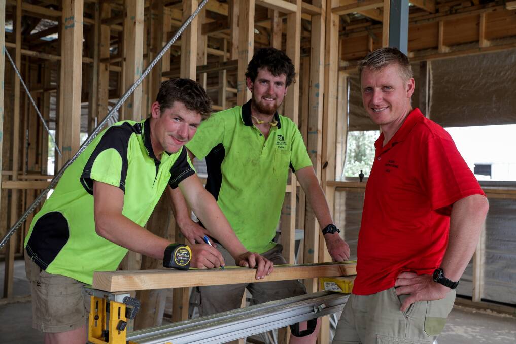 School-based apprentice James Coomber checks a measurement with carpenter Ryan Mitchell and Bolden Constructions director Leigh Dufty. Picture: Rob Gunstone