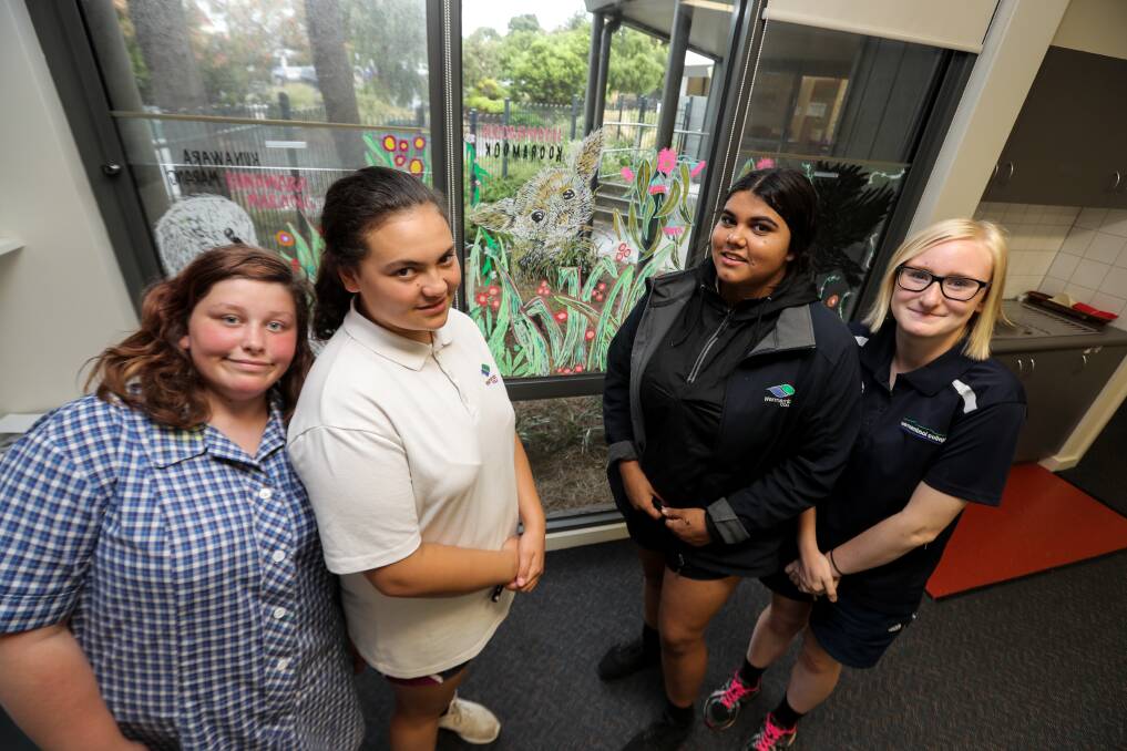 GREAT WORK: Warrnambool College Kalay Academy students l-r Harmony Symonds, 14, Kelly Tokona, 15, Jindara Chatfield, 16, and Aimee Dougan, 17, work on a mural at Warrnambool City Council's Children and Family Services. Picture: Rob Gunstone