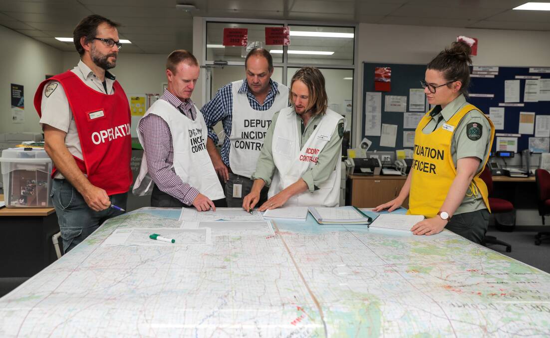 Taking action: Warrnambool nurdle spill incident controller Tim Gazzard (second from right) talks to his team about the emergency in the control room. Picture: Rob Gunstone