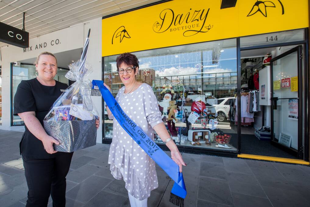 WINNER: Commonwealth Bank customer service manager Adele Griffin presents Daizy Boutique owner Maree Wills with a hamper. Picture: Christine Ansorge
