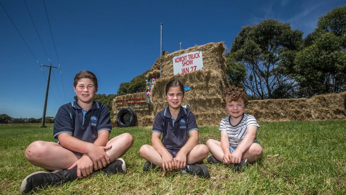 Louis McCosker, 11, Ruby McCosker, 8 and Billy Finnigan, 4 in front of the Koroit Truck Show hay truck on Princes Highway. Picture: Christine Ansorge