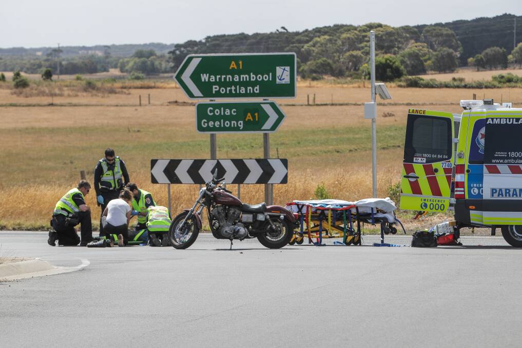 Help on hand: Emergency services help a motorcycle after a collision at  Allansford. Picture: Morgan Hancock