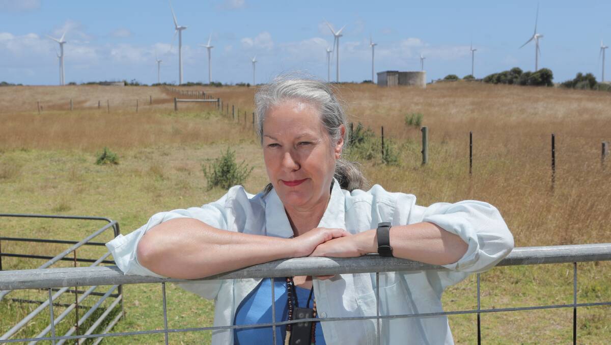 Health concerns: Melissa Ware in her backyard, in front of turbines from the Cape Bridgewater wind farm near Portland. Picture: Morgan Hancock