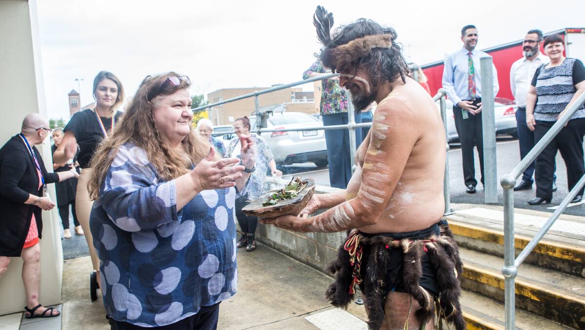 Cleansing: Aboriginal dancer Brett Clarke invites people to be cleansed by smoke at a smoking ceremony outside the Department of Health and Human Services Warrnambool centre. Picture: Christine Ansorge