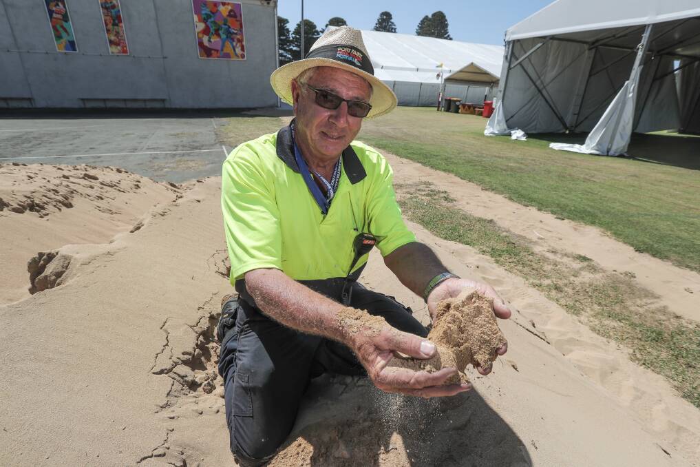 GRAINY: Port Fairy Folk Festival construction crew leader Jack Smits with the sand that will be used to create a beach.