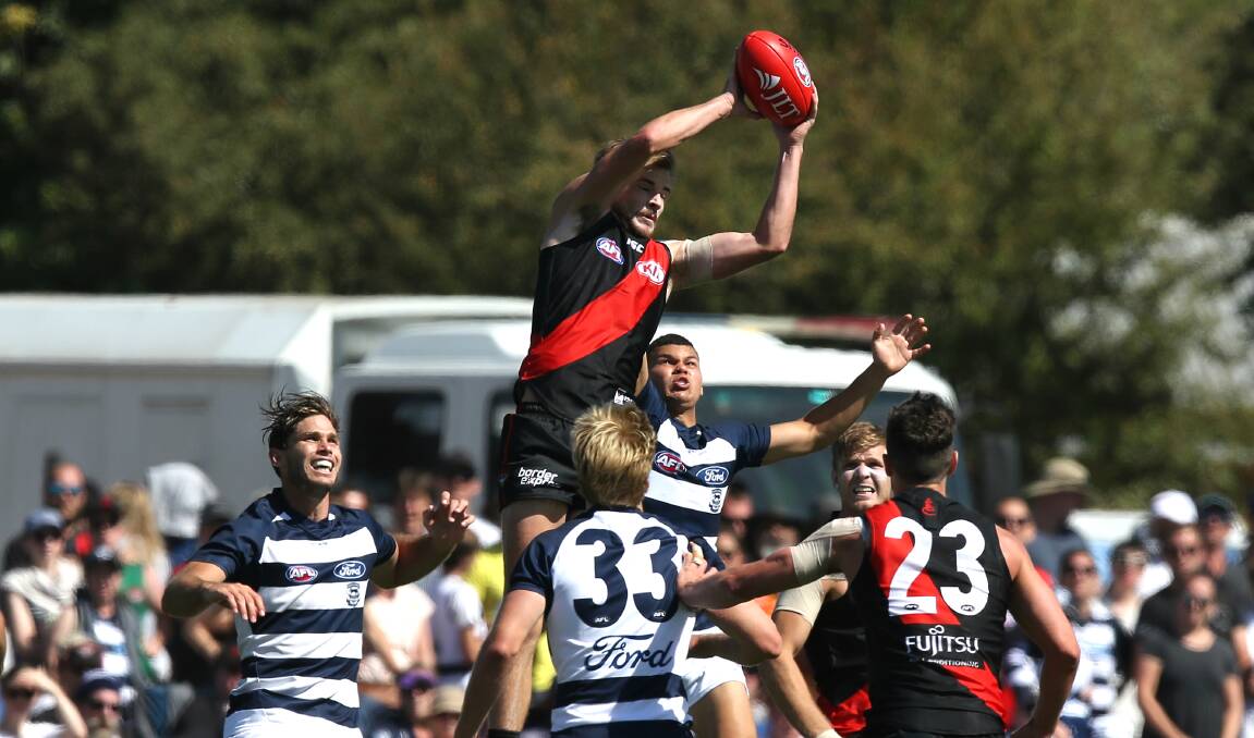 HIGH BEFORE A LOW: Essendon's Marty Gleeson flies for a mark in the Bombers' JLT contest on Sunday. He was injured later in the match. Picture:Wayne Ludbey