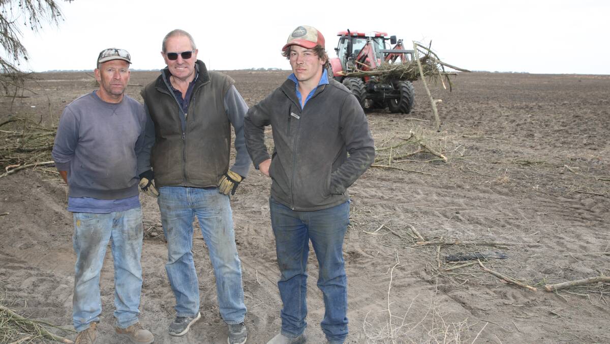 Tasks ahead: Terang farmers Kevin. left, and David, right, Langley with Chris Wilkinson, take a break from clearing up after Saturday's fires. 