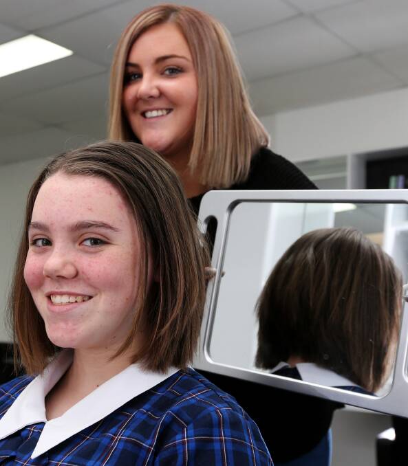 Chop and change: Elise Drake models her new, shorter hairstyle after hairdresser Shannon McNeil chopped it for charity. Picture: Rob Gunstone