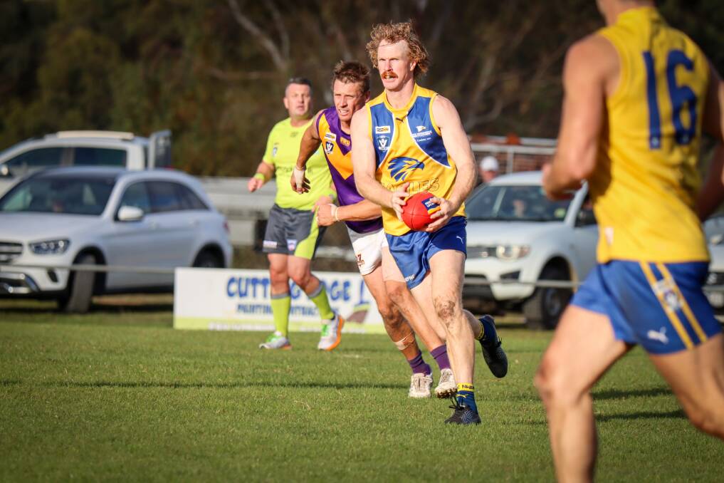 Luke Wines runs the ball out of defence for North Warrnambool Eagles. Picture by Justine McCullagh-Beasy 