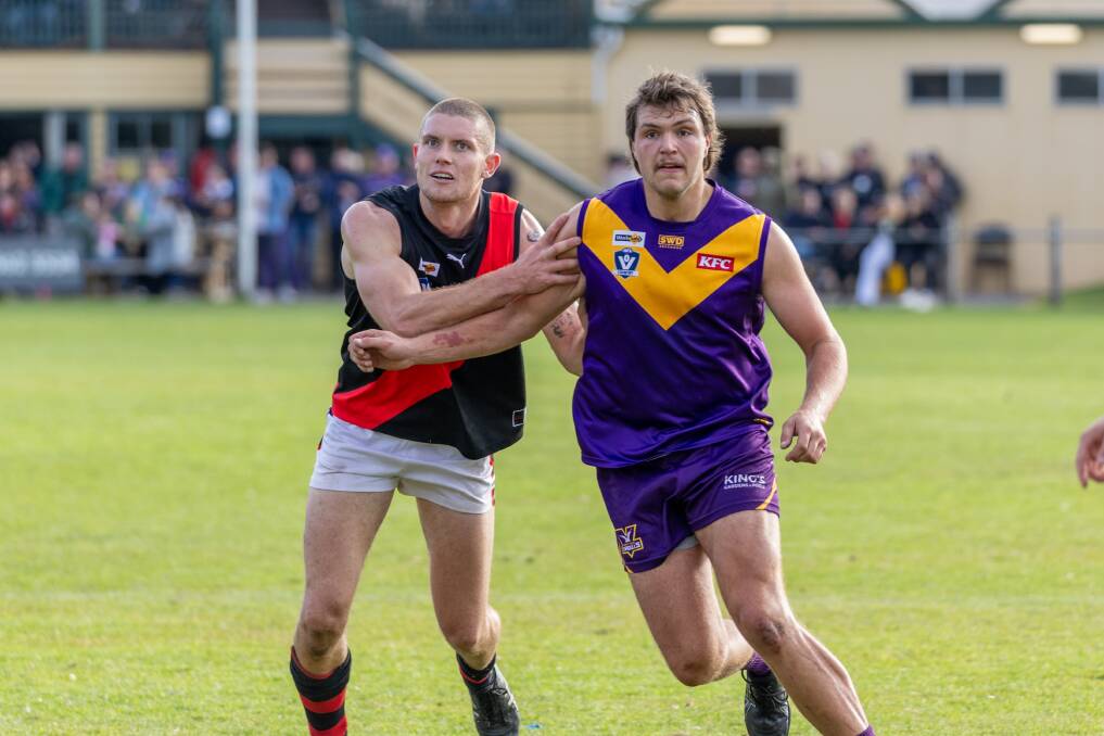 Cobden footballer Tim Auckland and Port Fairy counterpart Jake Bartlett compete in the ruck. Picture by Eddie Guerrero 