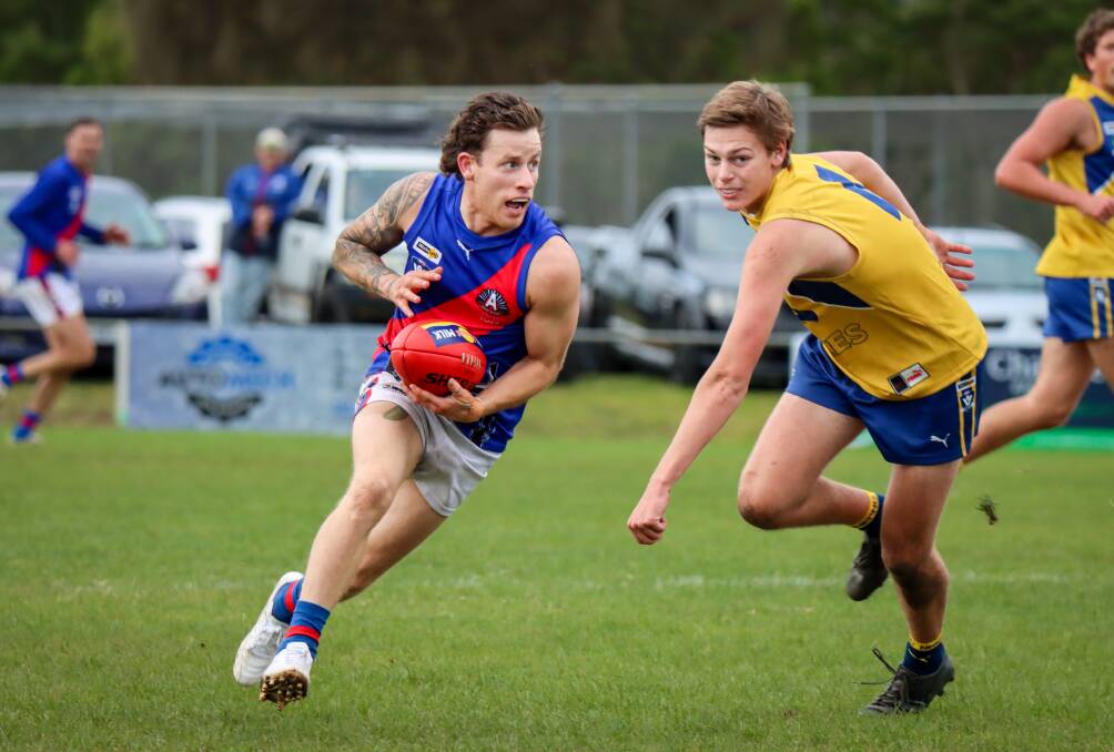 Terang Mortlake's Ben Reid escapes the clutches of North Warrnambool Eagles' Duke Bermingham. Picture by Justine McCullagh-Beasy 